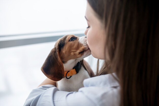 pet owner holding her cute puppy looking happy 259150 55295